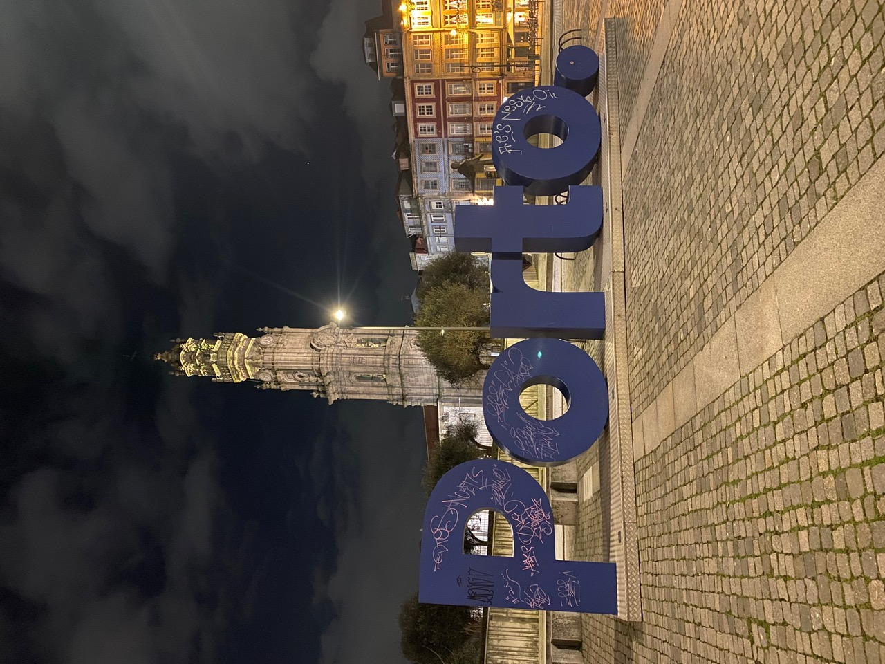 The Porto sign and Clérigos Tower lit up at night